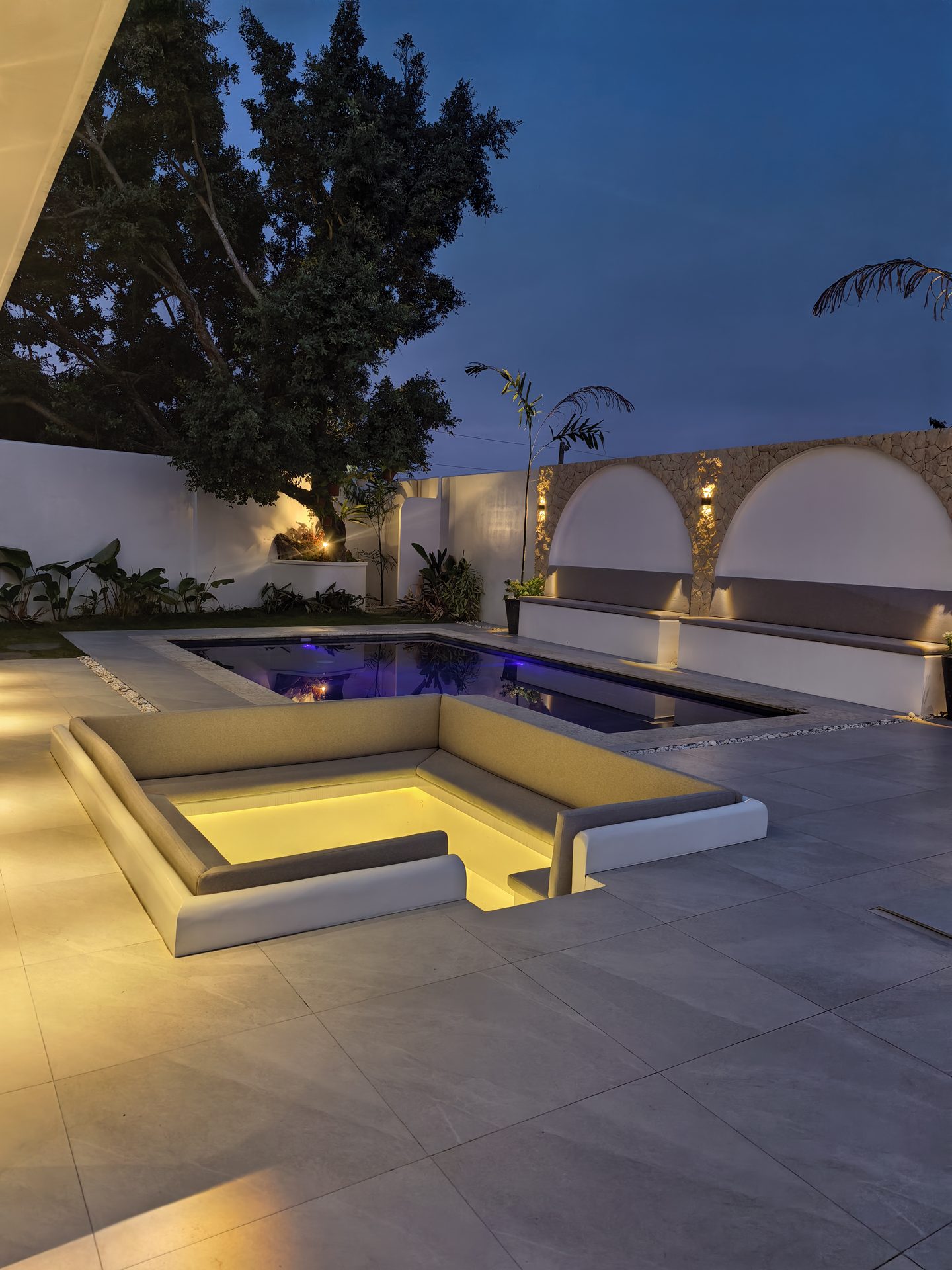 Illuminated sunken lounge and private swimming pool at night - Hacienda Salinas Lahug